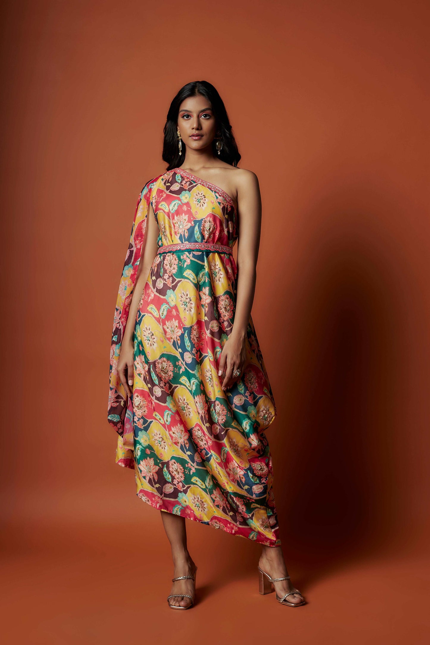 Slub linen satin & soft linen georgette multi printed one shoulder dress with open cowl sleeve and matching belt.