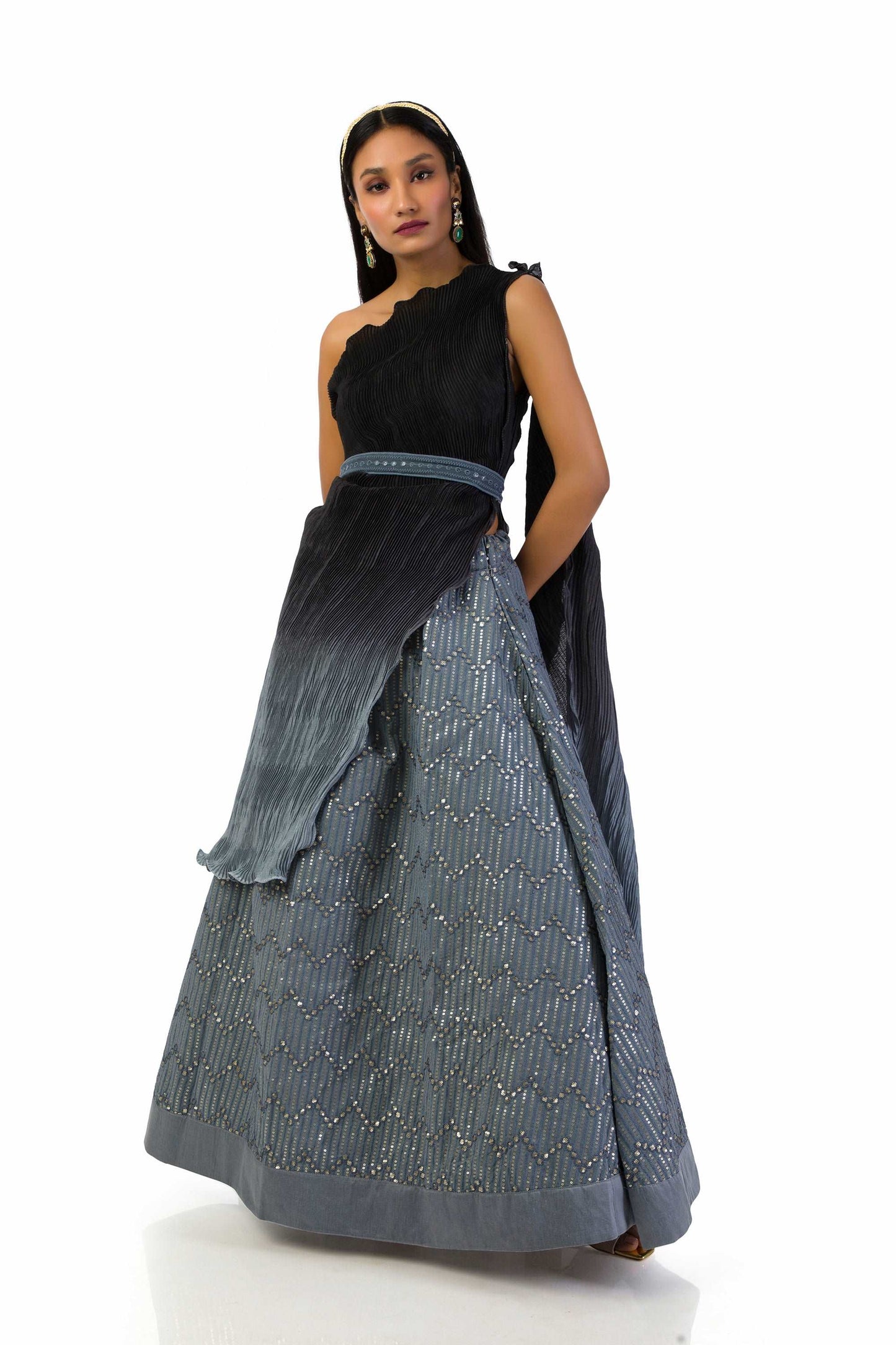 Grey to Black One-Shoulder Top with Lehenga featuring a textured top, attached dupatta, matching belt, and a fully lined georgette skirt with sequins and thread work.