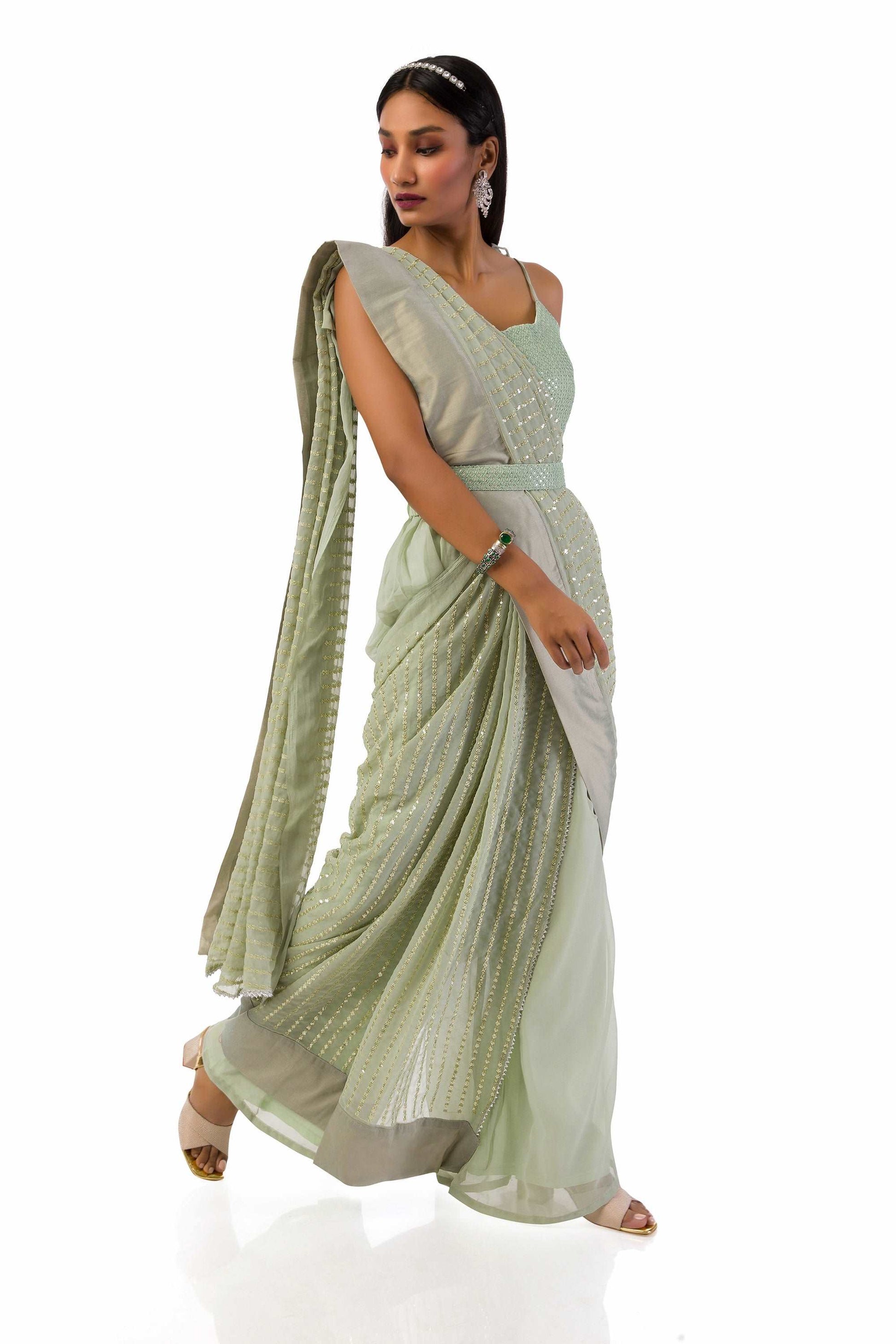 Model wearing an elegant olive green stitch drape saree set with intricate details.