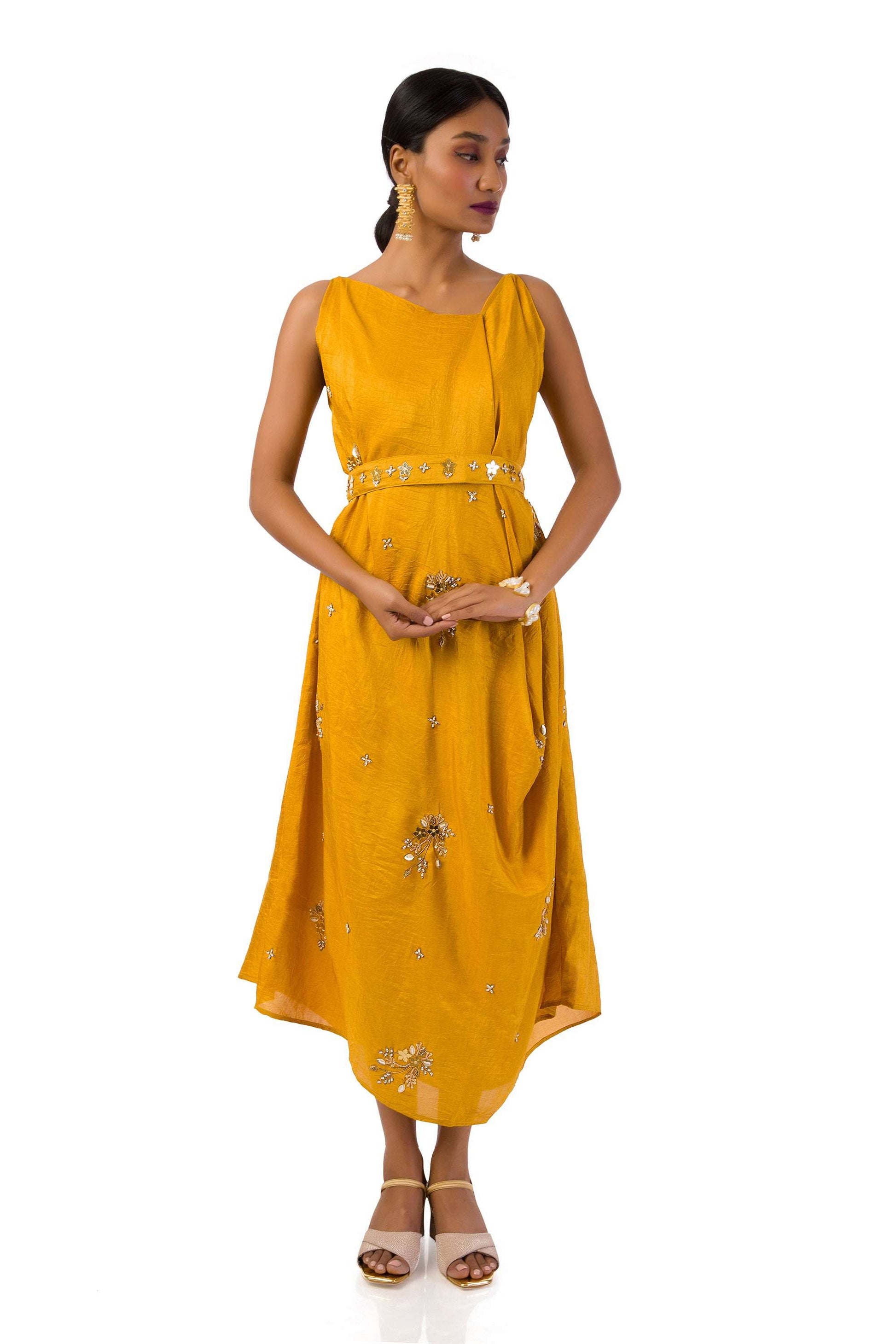 Woman wearing an elegant mustard Mahanadi dress with hand embroidery and a matching belt