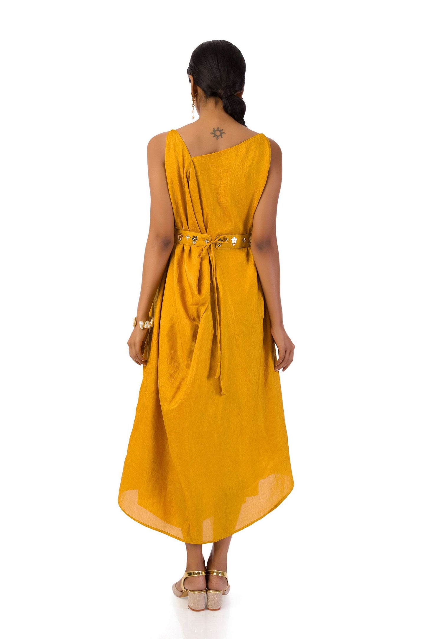 Woman wearing an elegant mustard Mahanadi dress with hand embroidery and a matching belt