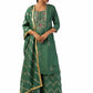 Woman wearing a dust green semi-silk kurta set with hand embroidery and print, paired with matching palazzo pants and dupatta.