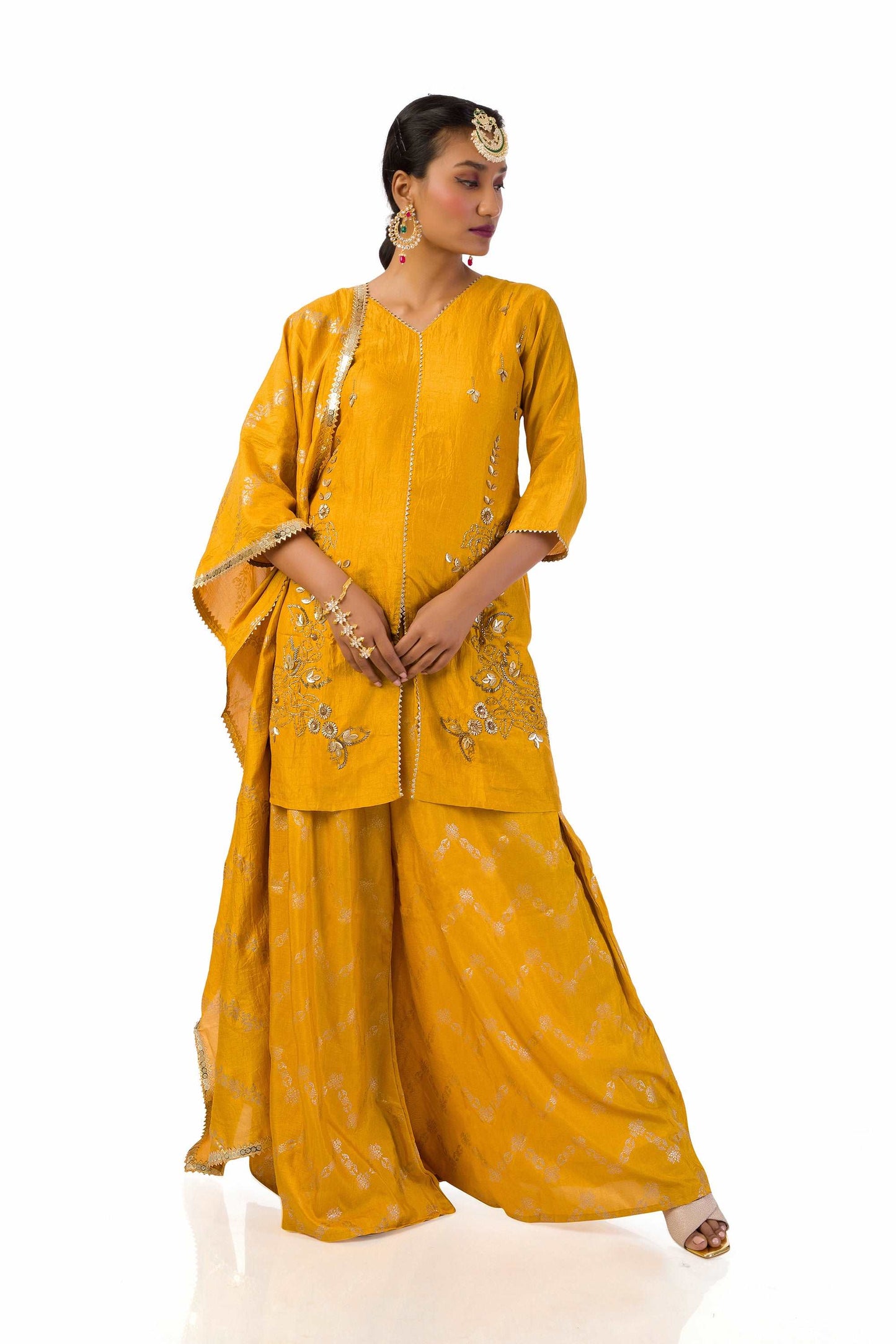 Woman wearing mustard yellow embroidered suit set with dupatta