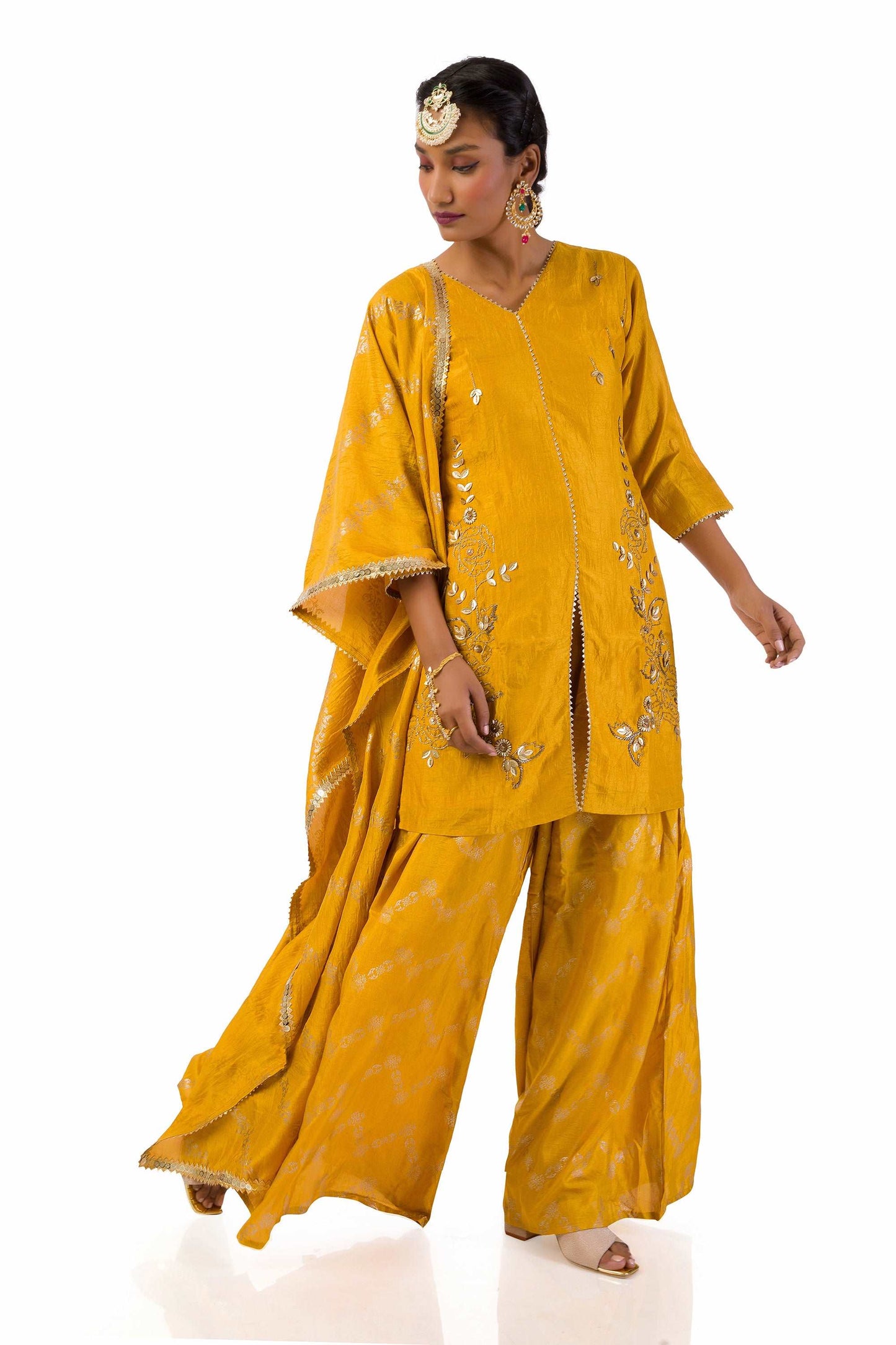 Woman wearing mustard yellow embroidered suit set with dupatta