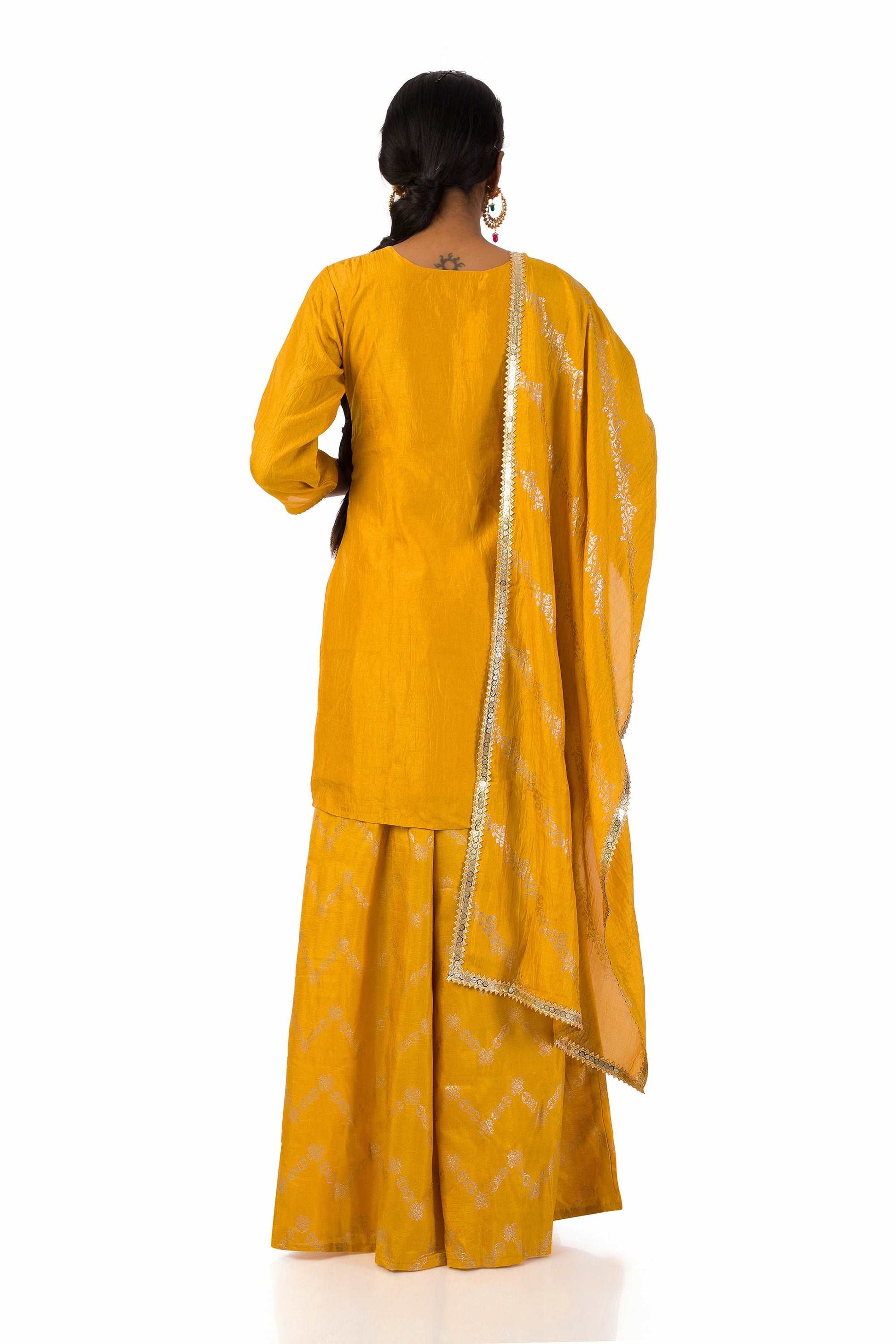 Woman wearing mustard yellow embroidered suit set with dupatta