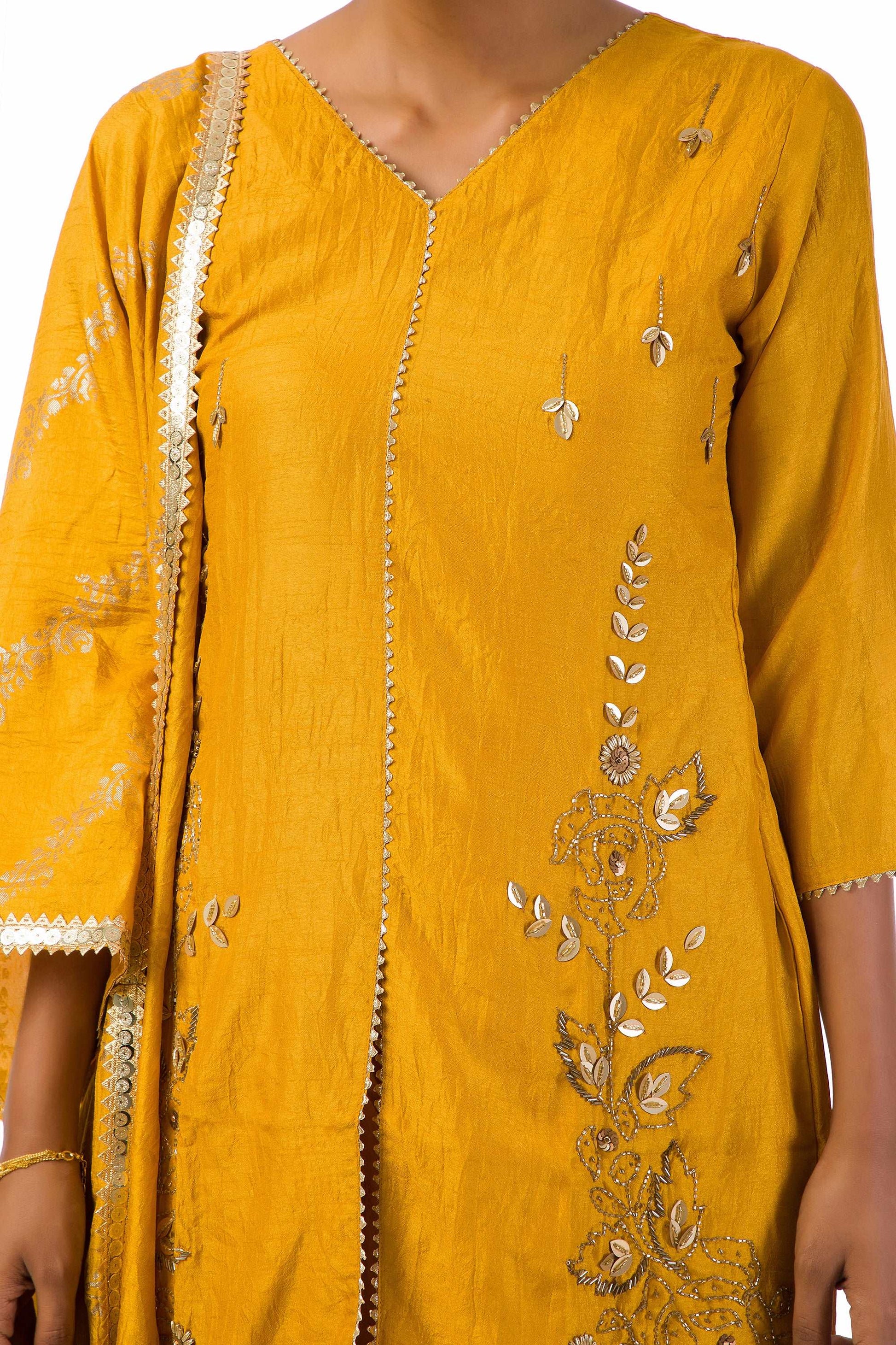 Woman wearing mustard yellow embroidered suit set with dupatta