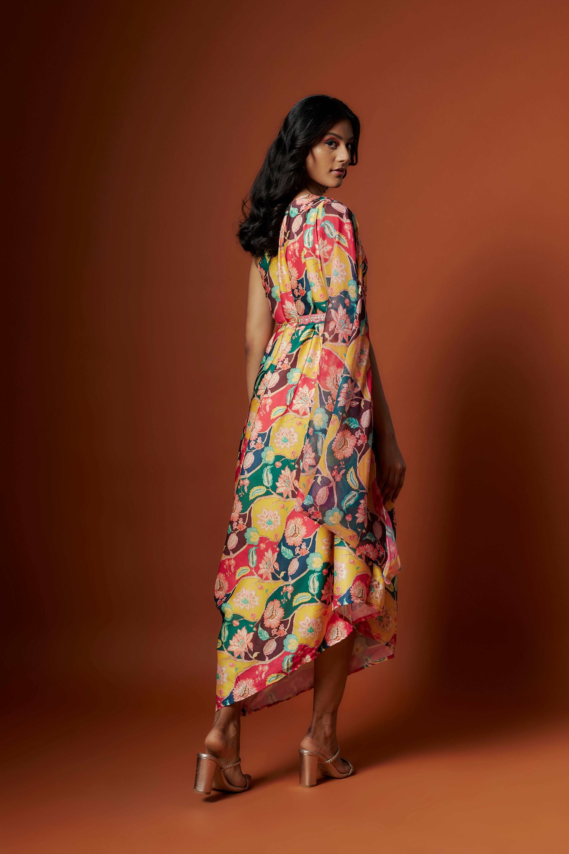 Slub linen satin & soft linen georgette multi printed one shoulder dress with open cowl sleeve and matching belt.