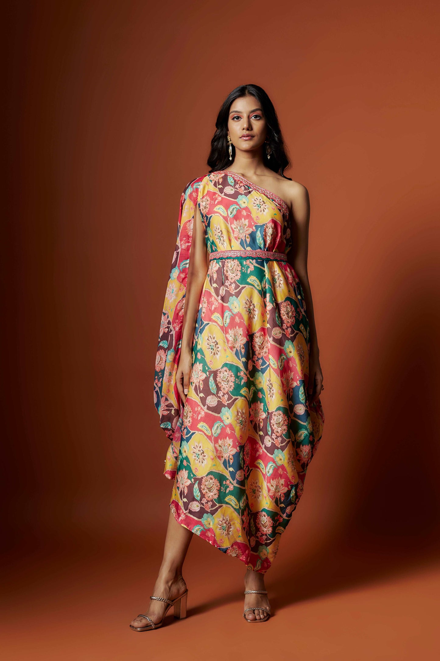 Slub linen satin & soft linen georgette multi printed one shoulder dress with open cowl sleeve and matching belt.