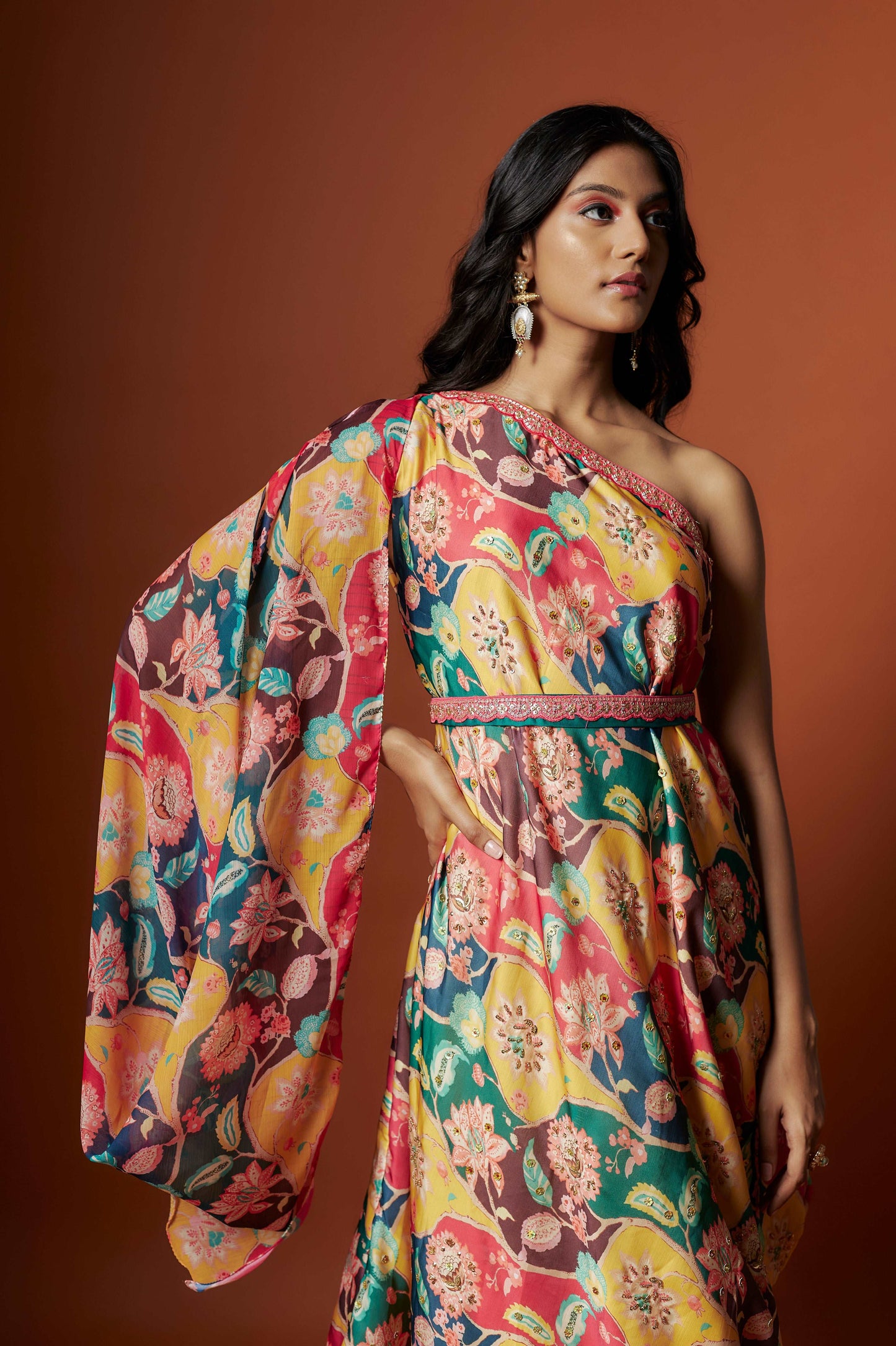 Slub linen satin & soft linen georgette multi printed one shoulder dress with open cowl sleeve and matching belt.