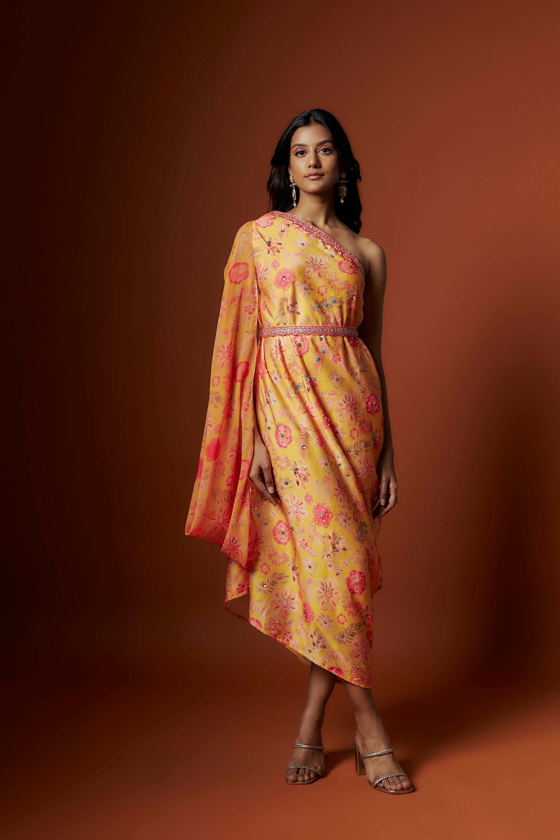 Slub linen satin & soft linen georgette yellow printed one shoulder dress with open cowl sleeve and matching belt.