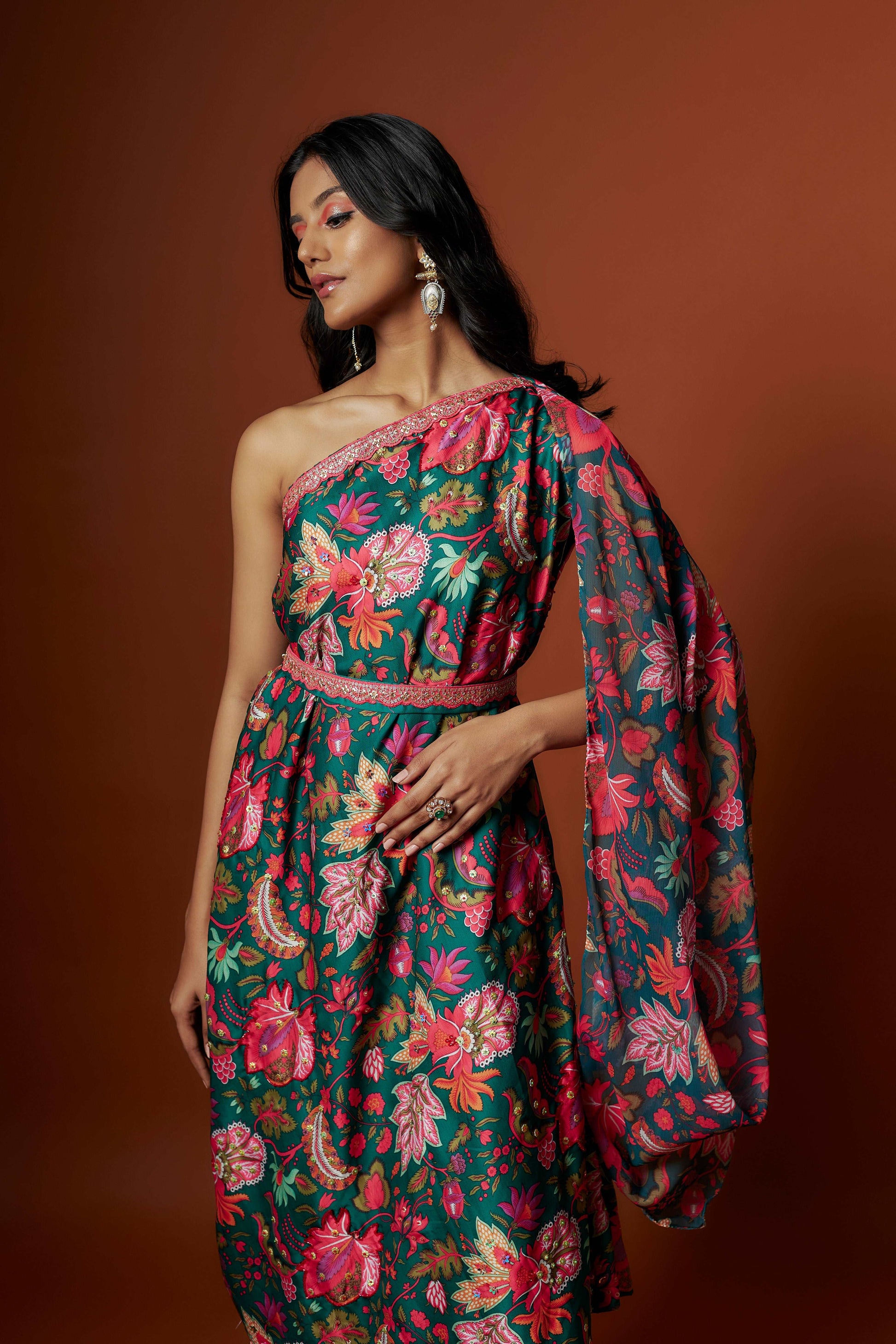 Slub linen satin & soft linen georgette green printed one shoulder dress with open cowl sleeve and matching belt.