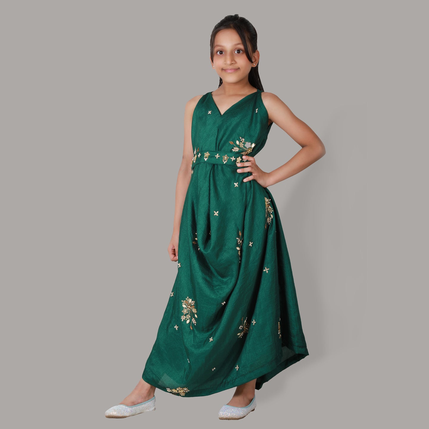 Girl wearing a bottle green centre cowl dress in semi-silk with hand embroidery, paired with a matching belt.