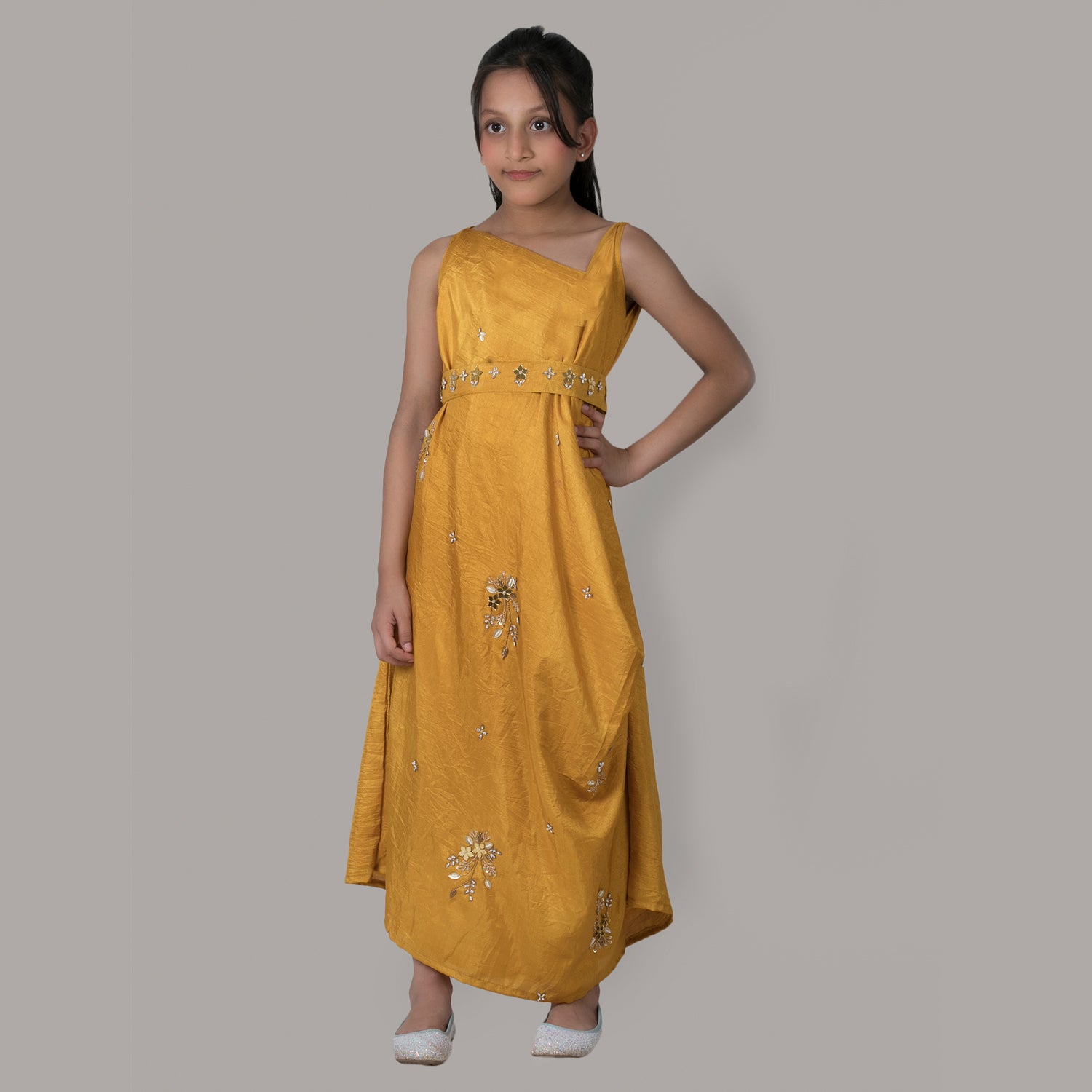 Girl wearing a mustard draped side cowl neck dress with hand embroidery and a matching belt