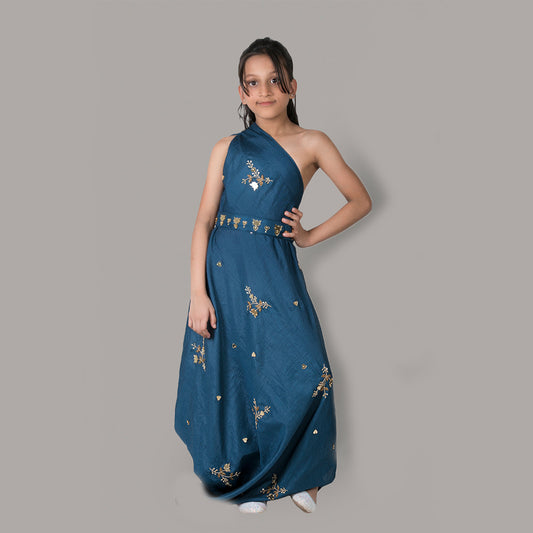 Girl wearing a Dark Blue One-Shoulder Draped Gown with Hand Embroidery and matching belt, made from semi-silk fabric.